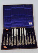A silver plated six-place setting of cake knives and forks, in fitted leather case, case w.28.5cm