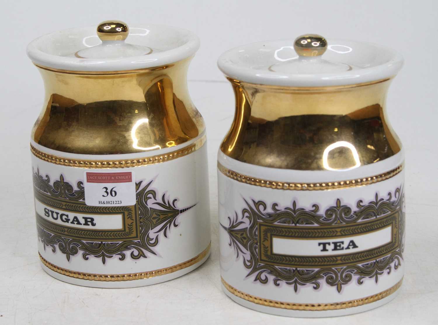 A pair of Robert Stewart pottery canisters, each inscribed Tea and Sugar, height 16cm