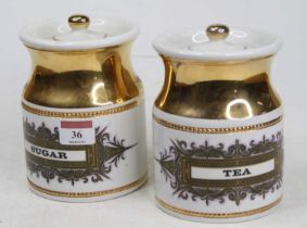 A pair of Robert Stewart pottery canisters, each inscribed Tea and Sugar, height 16cm