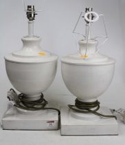 A pair of white painted wooden table lamps, each of baluster form, height including fittings 44cm
