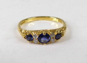 An Edwardian style 18ct gold sapphire and diamond dress ring, arranged as three graduated round