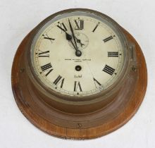 An early 20th century brass cased ship's bulkhead clock, the painted dial with Roman numerals and