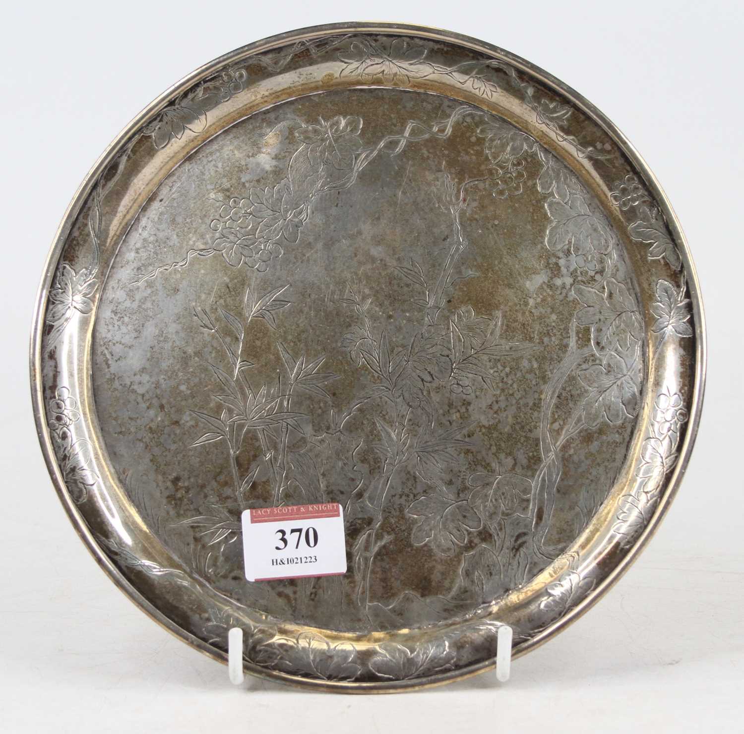 A Chinese silver plate, having a raised rim, the whole engraved with flowering bamboo, maker Wang
