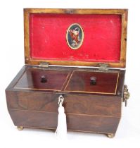 A Regency rosewood twin compartment tea caddy, of sarcophagus form, flanked by twin brass lion