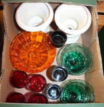 A collection of coloured glass ware to include a pair of green glass dessert bowls, four cranberry