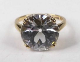 A 9ct gold and white sapphire set dress ring, the round cut white sapphire weighing approx. 7 carats