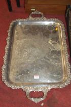 A Victorian style silver plated twin handled drinks tray, having engraved ground and raised leaf