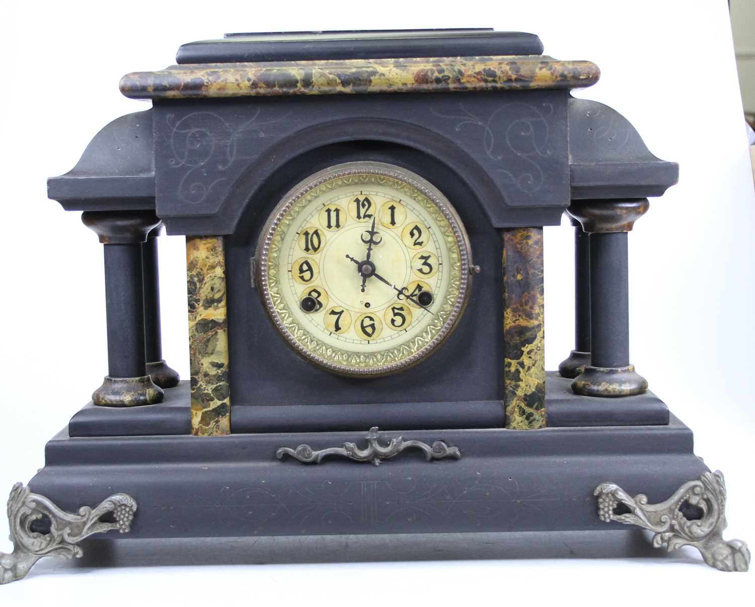A late 19th century American ebonised and faux marble mantel clock, with further gilt metal