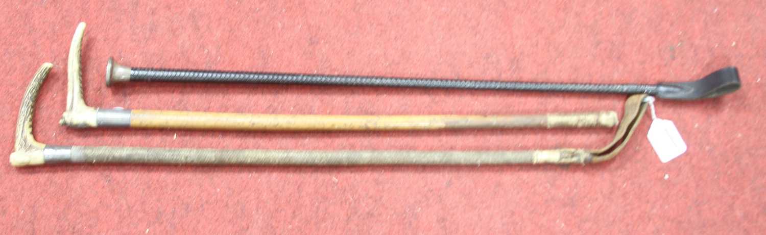 A mid 20th century leather riding crop having a silver clad handle, length 73cm together with two