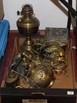 A collection of brassware to include a Victorian oil lamp and a spirit kettle