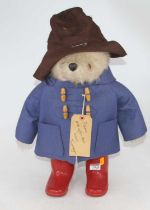 A vintage Paddington Bear wearing a hat, blue duffel coat, and red wellies, height 50cm In good