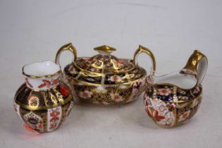 A Royal Crown Derby Imari sauce boat, height 8.5cm, together with a matching sugar and a Royal Crown