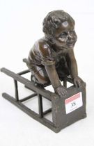 A bronze figure of a young boy upon a stool, height 17cm Appears to be intact and free from cracks.