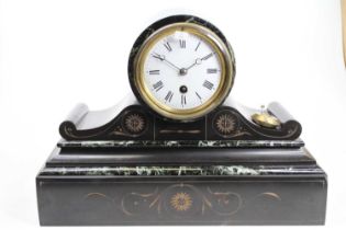 A late 19th century polished black slate drum head mantel clock, having a white enamel Roman dial,
