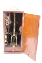 A 19th century brass monocular microscope, the mechanical stage above a Y-shaped foot, inscribed M