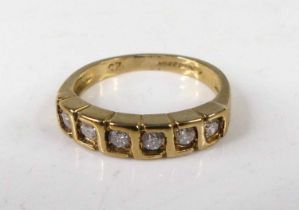 A modern 9ct gold diamond half eternity ring, arranged as six small round cuts in a line setting,