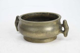A Chinese brass censer, flanked by twin handles, six character reign mark to the underside, width