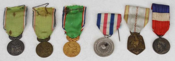 A collection of medals to include a WWII French commemorative war medal, various French Federation