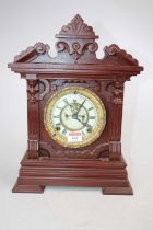 An early 20th century Ansonia mantel clock, the enamel chapter ring showing Roman numerals, having
