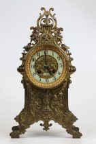 A 19th century French brass mantel clock, the enamel chapter ring showing Arabic numerals, having an