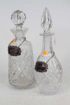 A modern cut glass decanter and stopper, together with a cylindrical example, each with a single