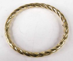 A hollow yellow metal ropetwist bangle, apparently unmarked but tests as 9ct gold, 12.5g, 7cm