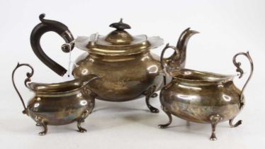 An Edwardian silver three-piece tea service, each of undecorated oval bombe form, with engraved