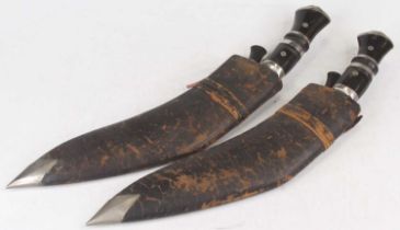 A 20th century kukri, having a polished blade with engraved decoration and lion mask capped