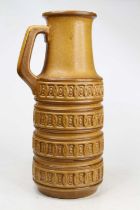 A West German yellow glazed pottery vase, having a single handle and geometric decoration, height