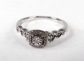 A contemporary 9ct white gold diamond dress ring, centre illusion set with a round cut diamond