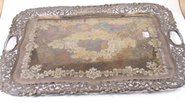 A late Victorian silver plated twin handled tray, having a raised pierced border and engraved ground