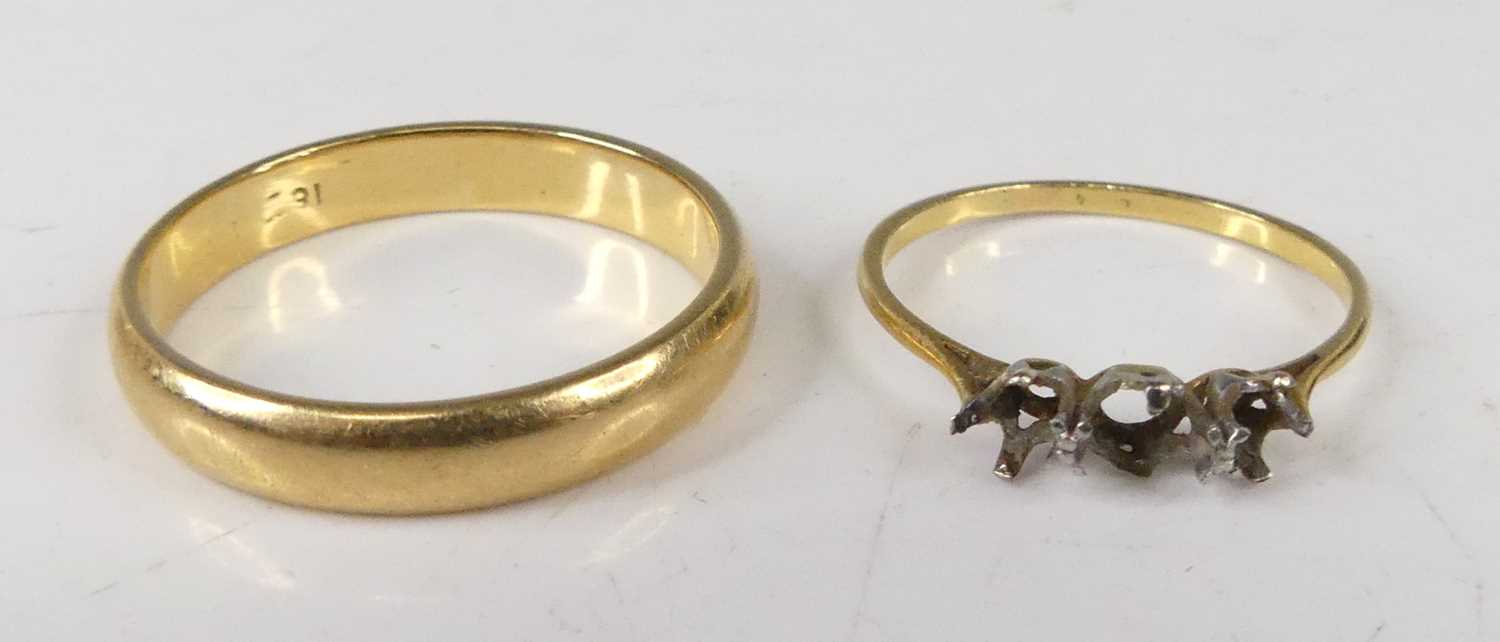 A yellow metal wedding band, unmarked but tests as approx 18ct gold, size Z+1; together with a