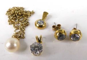 A modern 18ct gold and cz set pendant, together with a gilt metal example, a pair of gilt metal