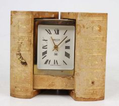 A Jaeger mystery travel clock disguised behind two gilt tooled leather books, mid-20th century, h.