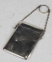 A George V plain silver card case on chain, with engraved monogram to the obverse, 1.9oz, 8cm