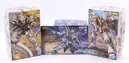 Three Bandai Gundam plastic model kits to include MG Gundam Heavy Arms EW Ver. (Mobile Suit Gundam