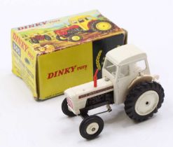 A Dinky Toys No. 305 David Brown tractor comprising of white and brown body with red smoke stack,