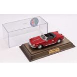 A Togi Toys of Italy 1/24th scale diecast model of an Alfa Romeo 1300 Spider, red body, with