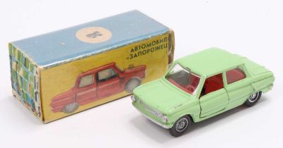 A Russian 1/43rd scale diecast model of a Zaz Zaporozhets, green body, with a red interior, and