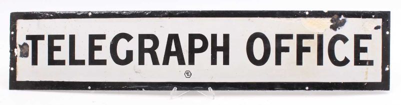 An original white enamel sign marked "Telegraph Office" has 8 fixing holes, some repaired damage