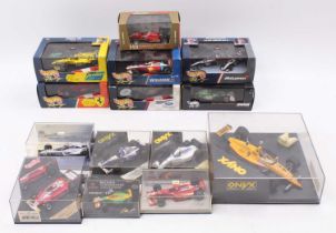 A collection of Formula 1 diecasts, including a 1/43rd scale Hot Wheels 1999 Ferrari F399, a