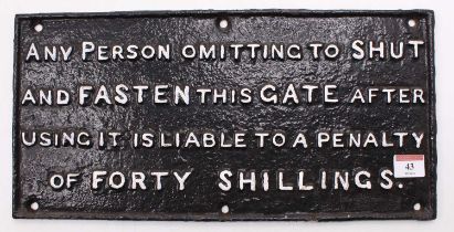A cast iron shut the gate sign repaint, reading "any person omitting to shut and fasten this gate