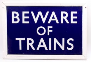 A wooden framed enamel sign "beware of trains". In excellent condition. measures 28 inches by 19