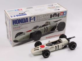 A Tamiya model No. 23201 1/12 scale factory built model of a Honda F1 RA272 race car (1965 Mexico