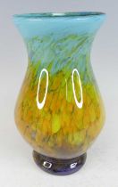 A Monart style art glass vase, of lower baluster form to circular pronounced foot, with bright