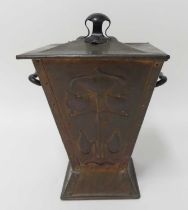 An Art Nouveau copper coal purdonium and cover, of square tapering form, having twin black painted