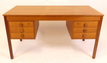 A 1960s Danish teak kneehole writing desk, having a plain top with twin flights of three short