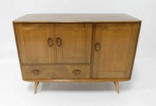 A 1960s Ercol blond elm Windsor 366 compact sideboard, having an arrangement of three cupboard doors