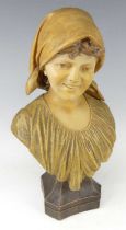 An Austrian Art Nouveau Goldscheider painted pottery female bust, looking to dexter and wearing