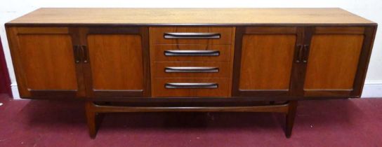 A 1960s G-Plan 'Fresco' teak long sideboard, having four central drawers flanked by twin cupboard